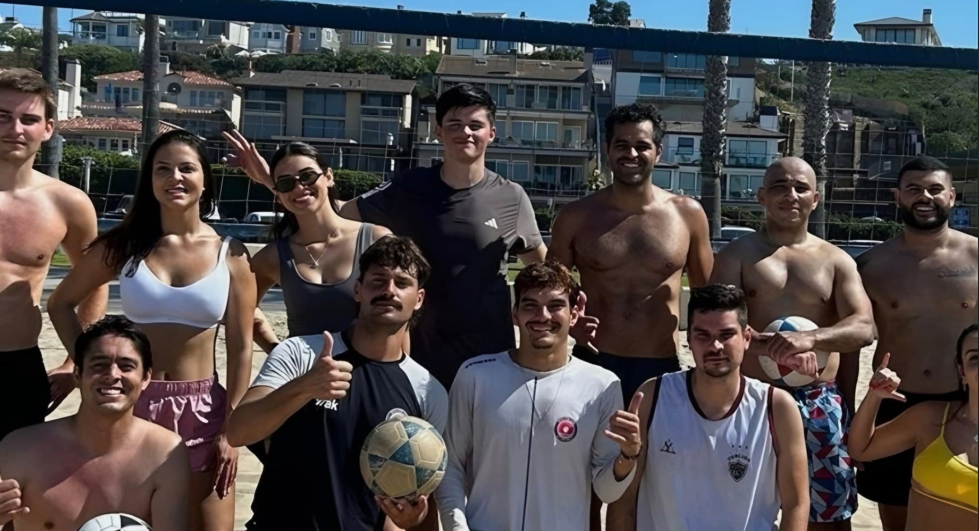 BPC players posing together by the net on a sunny beach