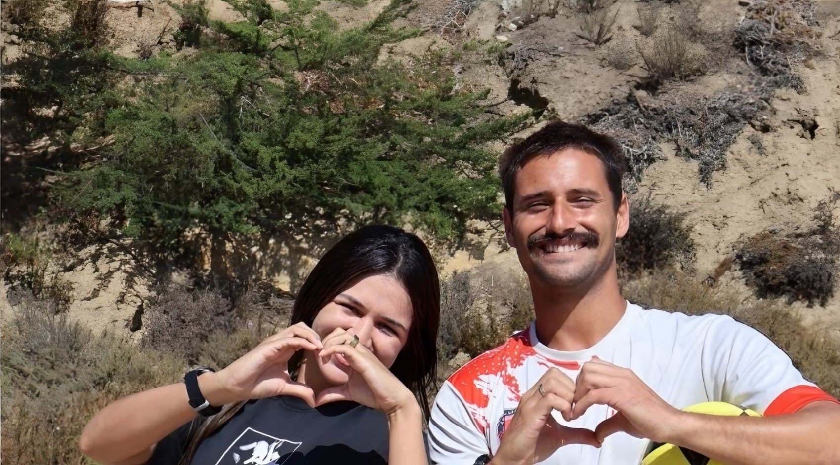 Two BPC members making heart shapes with their hands