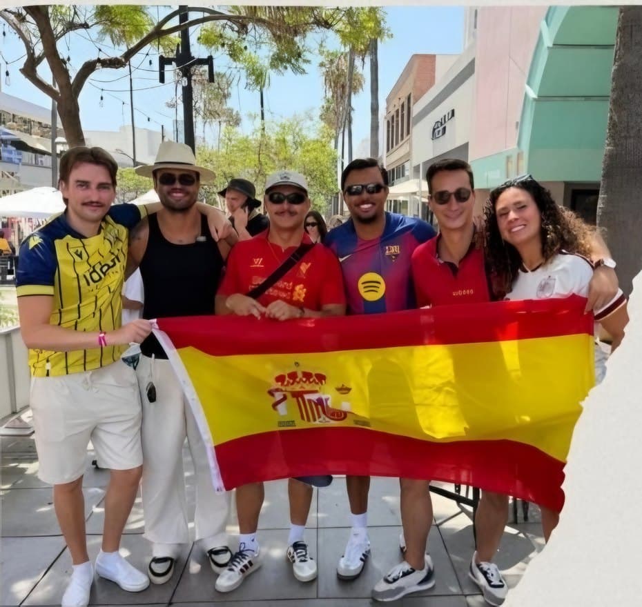 BPC friends holding a Spain flag at a World Cup watch party