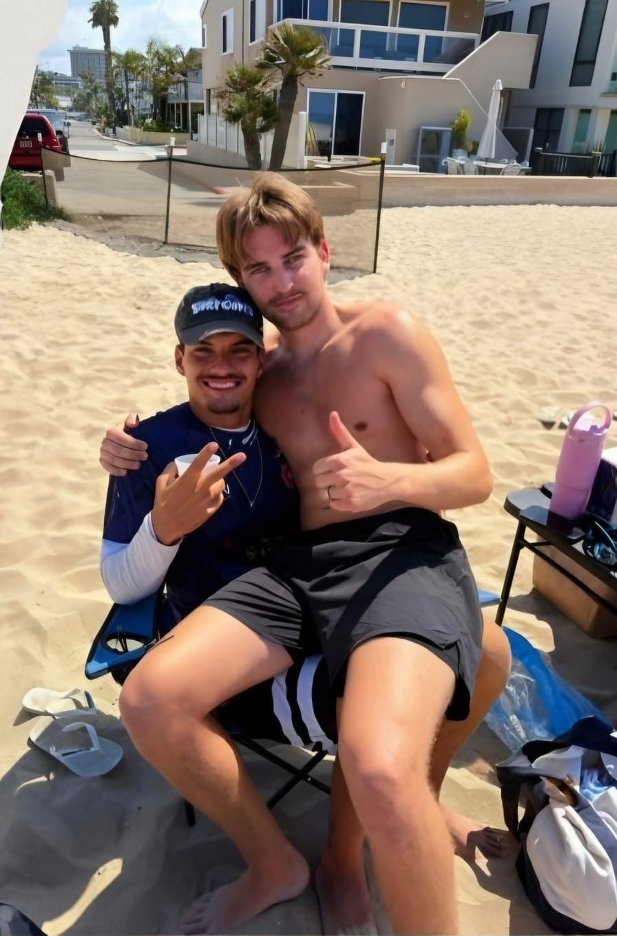 Two BPC players smiling together on the sand